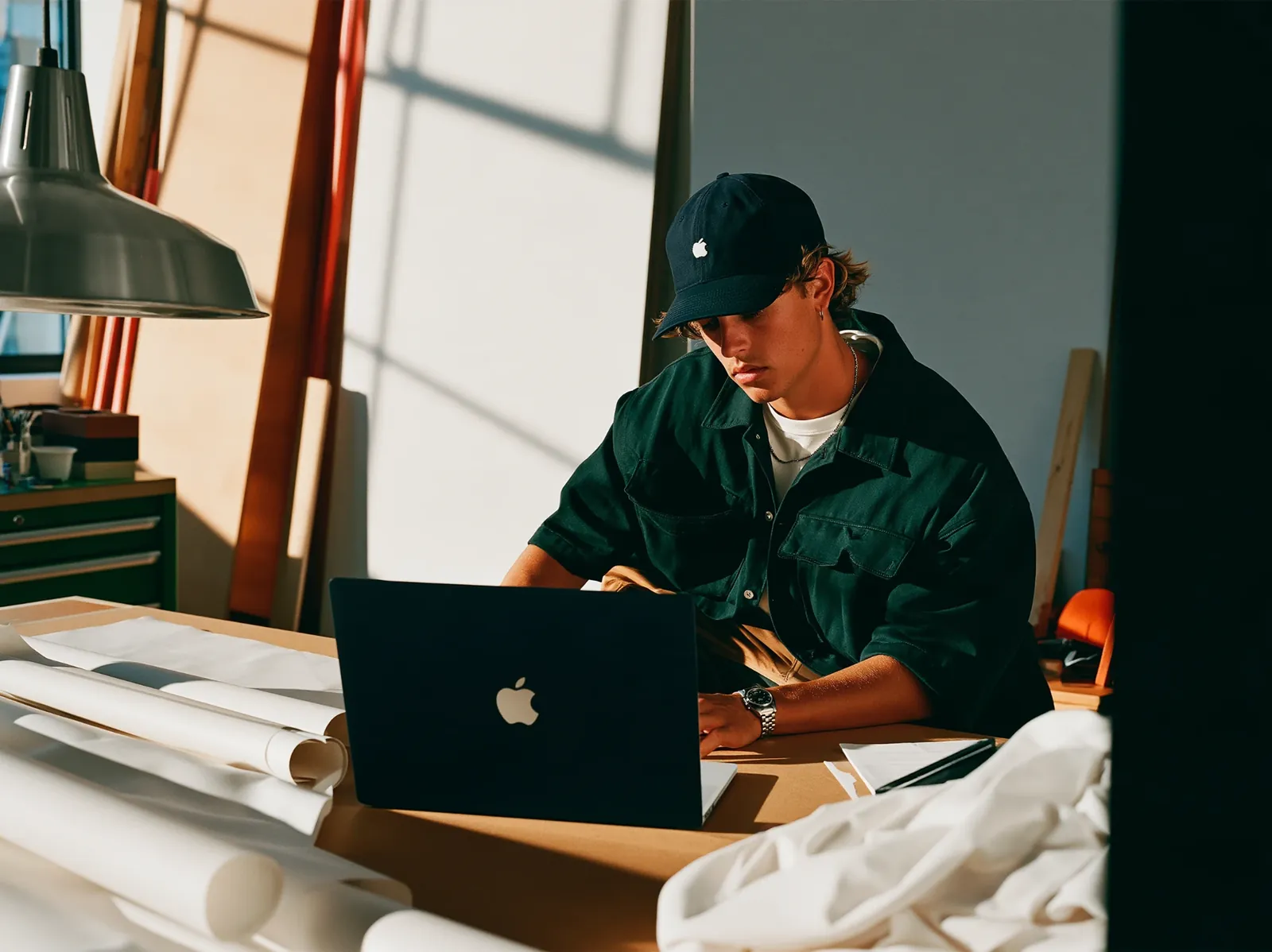 Person building a website on a laptop in a bright workshop, representing Aully's web development